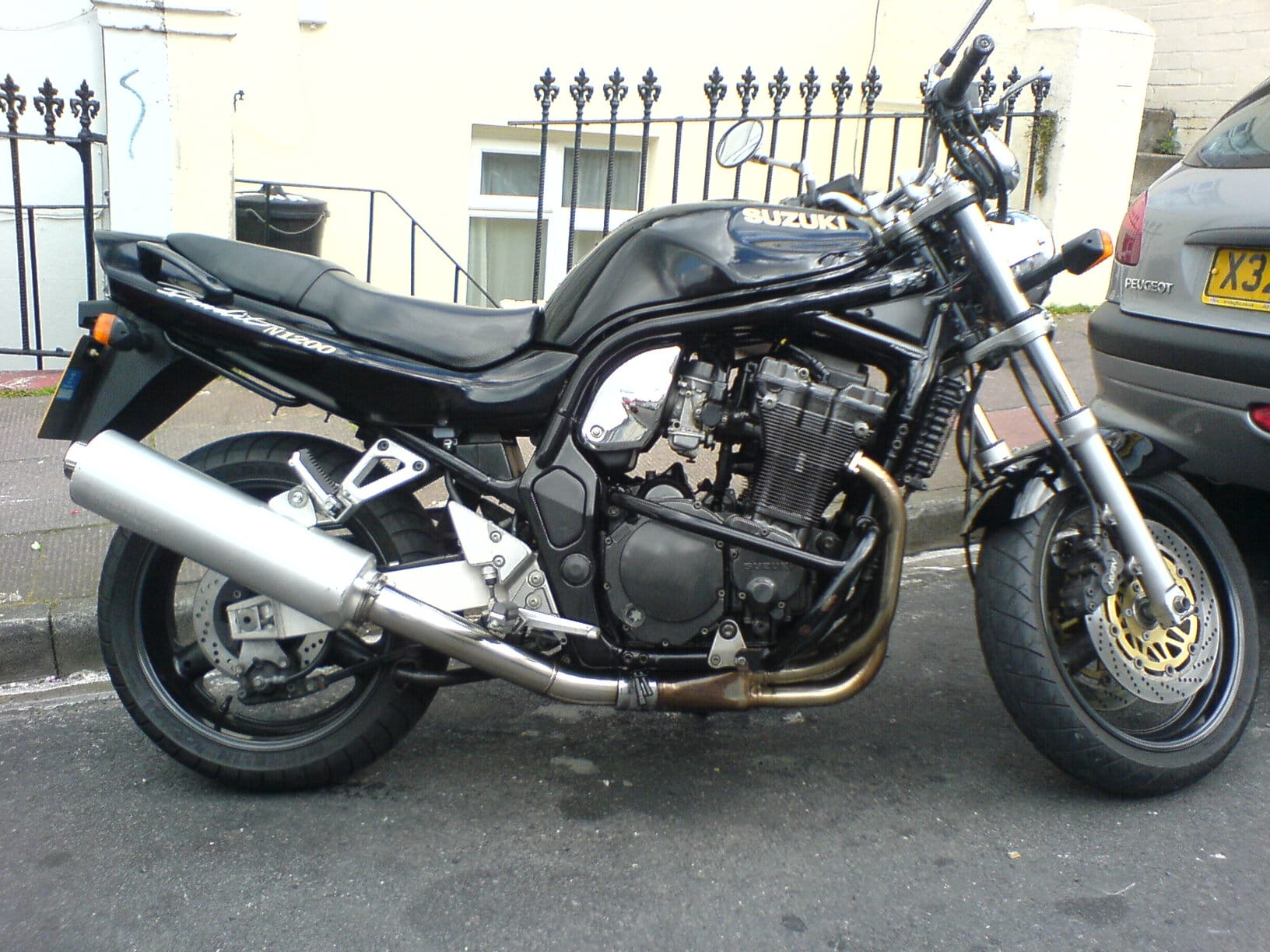 A Suzuki Bandit 1200 GSF naked bike used for daily riding and touring in the UK, highlighting the raw, unrefined power of a large-capacity air-cooled engine